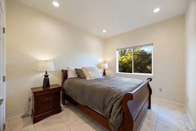 a bedroom with a bed and window