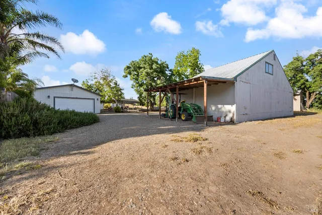 a view of a house with a yard and a garage