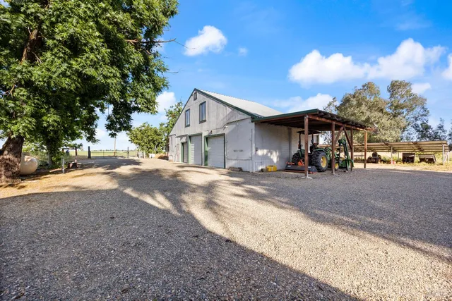 a view of a house with a yard and pathway