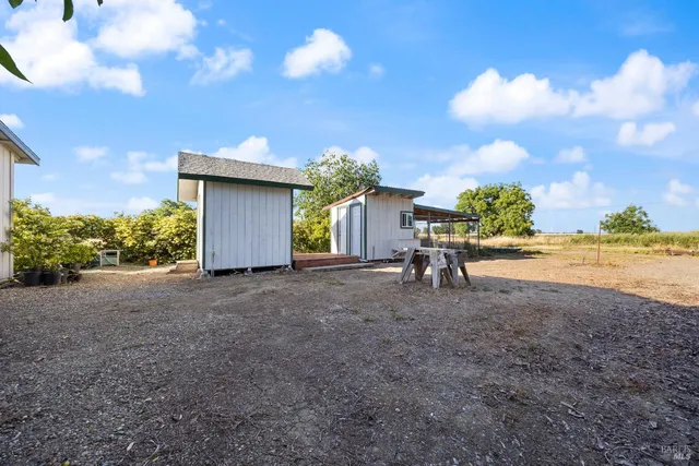 a view of a house with a yard and a garage