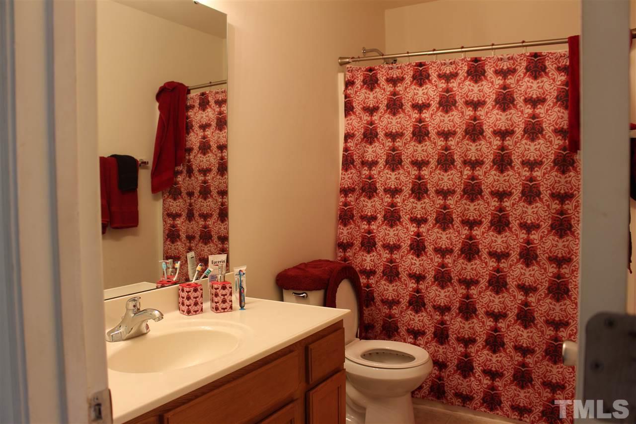 1432 Ricochet Drive Raleigh, NC 27610 - Photo 13 of 23 a bathroom with a sink and a mirror