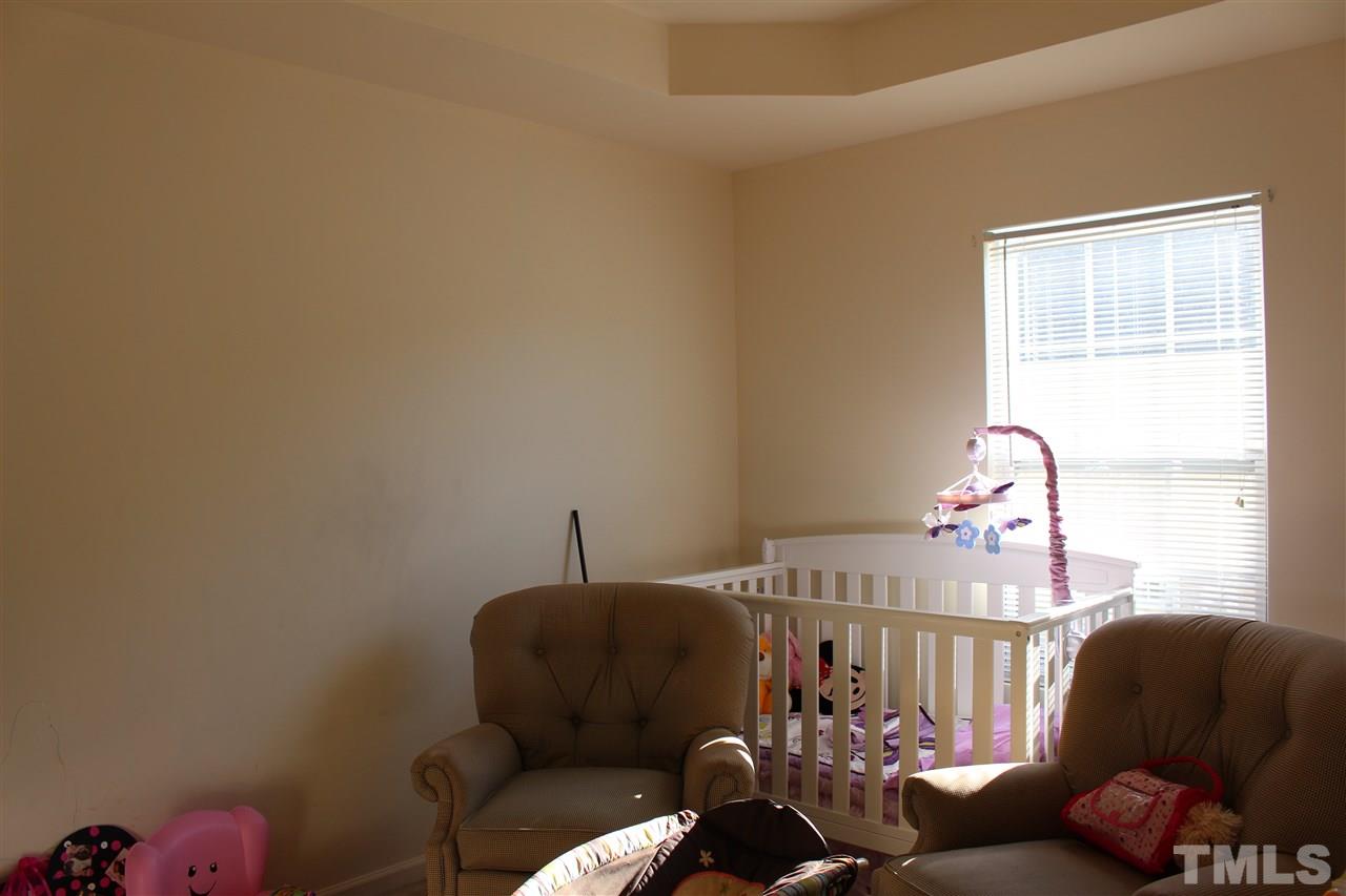 1432 Ricochet Drive Raleigh, NC 27610 - Photo 14 of 23 a bedroom with furniture and a window