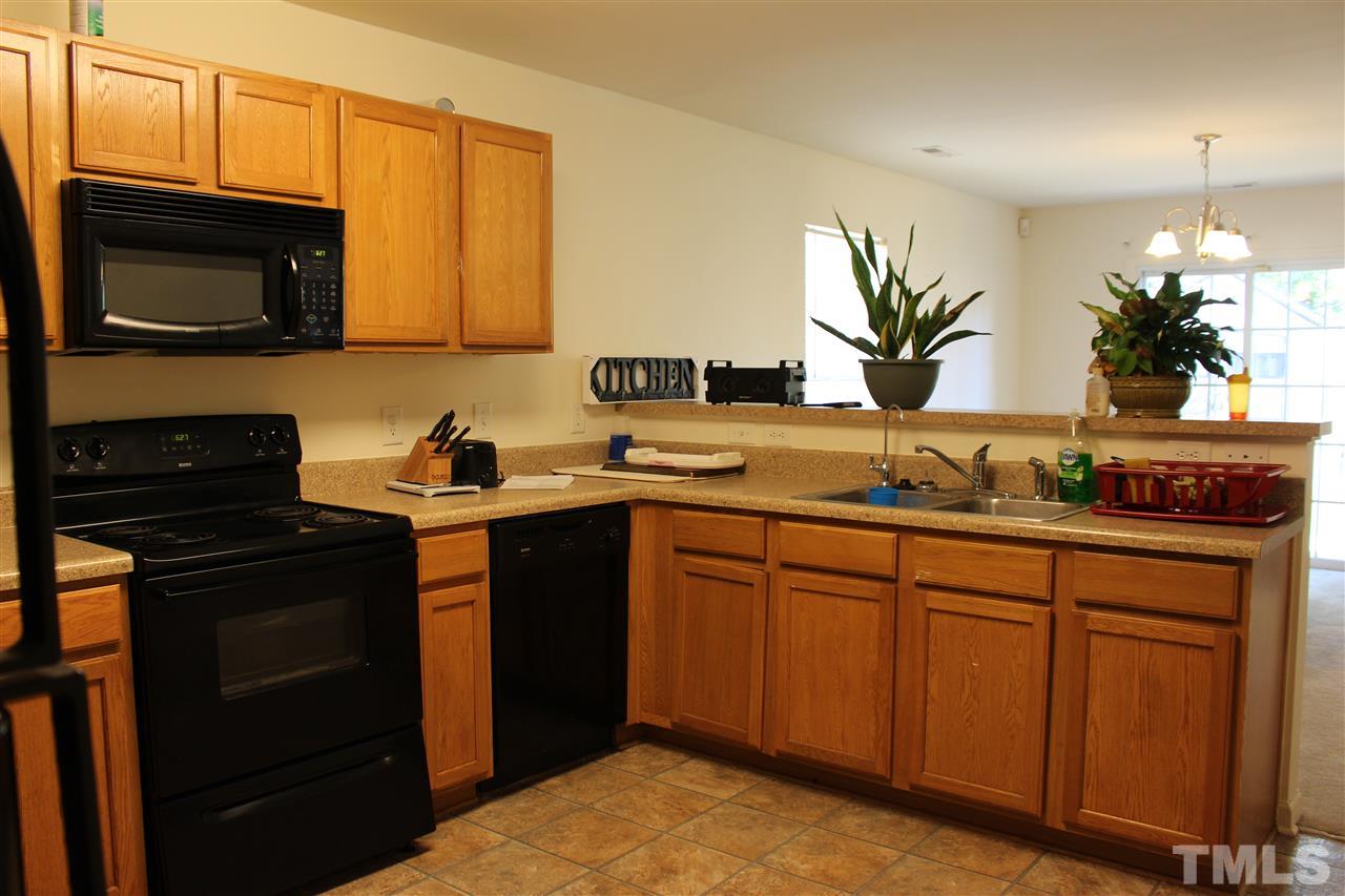 1432 Ricochet Drive Raleigh, NC 27610 - Photo 15 of 23 a kitchen with stainless steel appliances granite countertop a stove a sink and a microwave