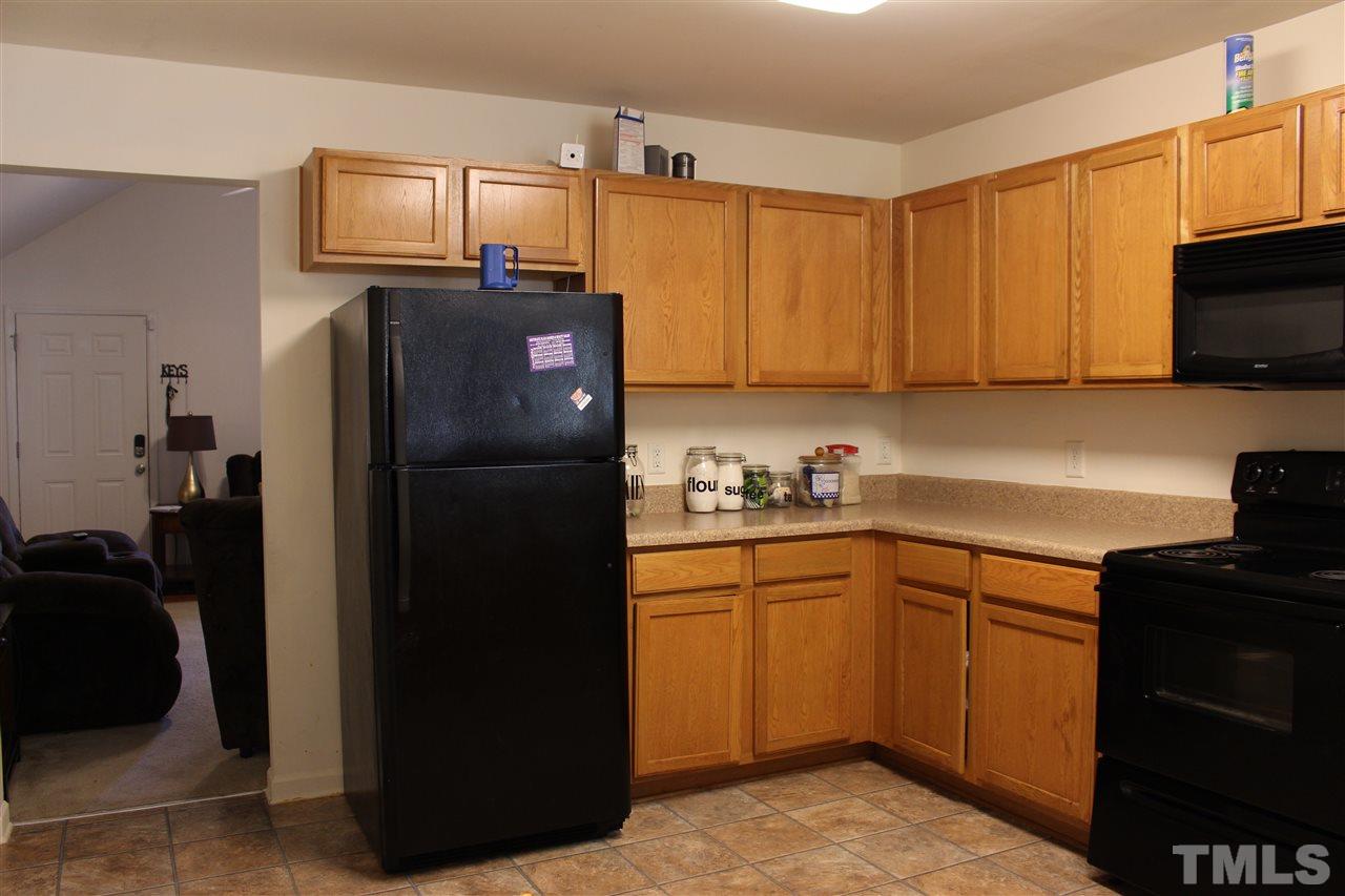 1432 Ricochet Drive Raleigh, NC 27610 - Photo 16 of 23 a kitchen with a refrigerator stove and sink