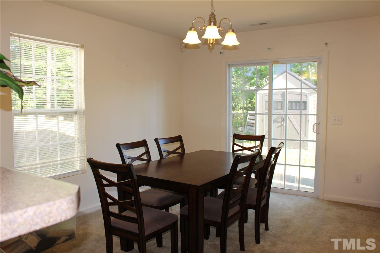1432 Ricochet Drive Raleigh, NC 27610 - Photo 17 of 23 a view of a dining room with furniture window and outside view