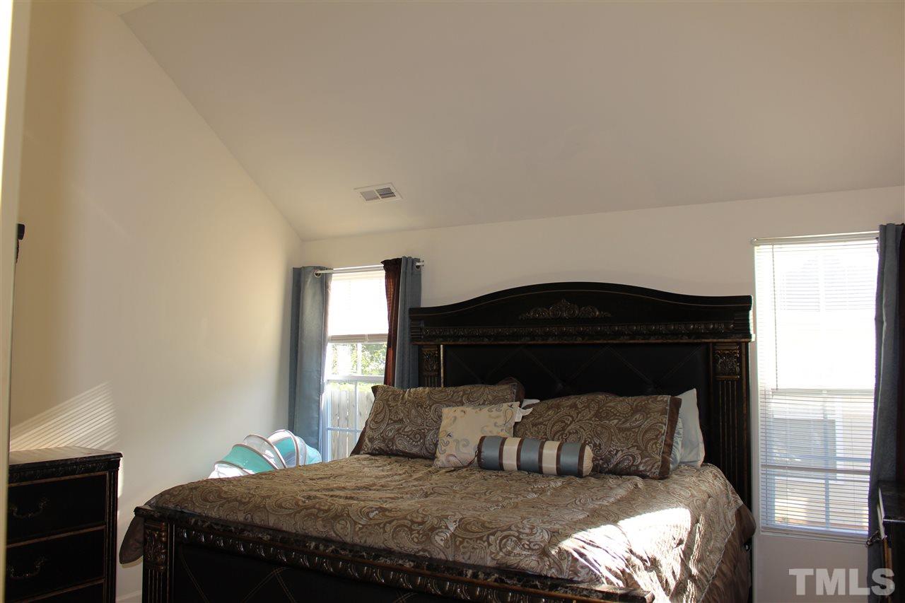 1432 Ricochet Drive Raleigh, NC 27610 - Photo 18 of 23 a bedroom with a bed and window