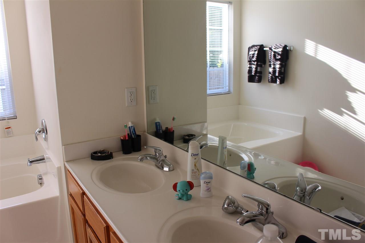 1432 Ricochet Drive Raleigh, NC 27610 - Photo 20 of 23 a bathroom with a sink and a mirror