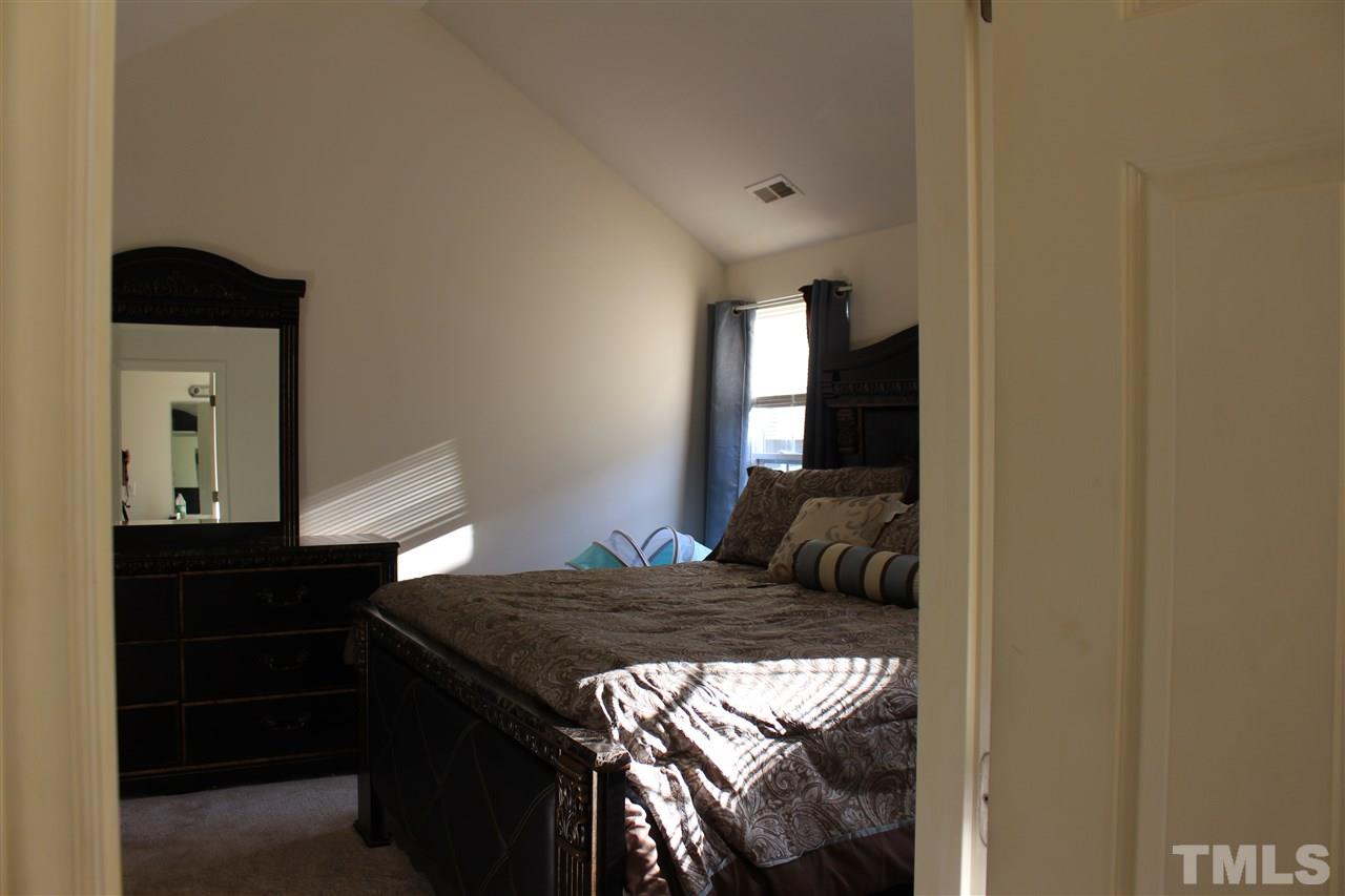 1432 Ricochet Drive Raleigh, NC 27610 - Photo 23 of 23 a bedroom with a bed and window