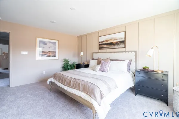 a bedroom with a bed and a painting on the wall