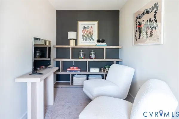 a living room with furniture a air conditioner and a window