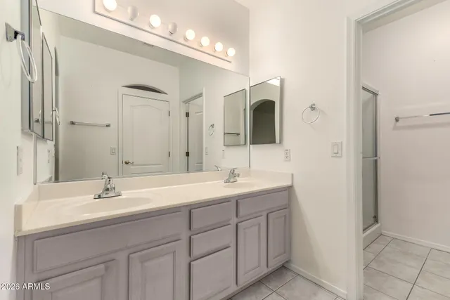a bathroom with a sink double vanity and a mirror