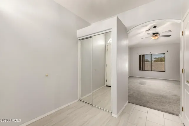 an empty room with a bathroom and mirror