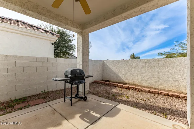 a view of a patio with table and chairs and potted plants