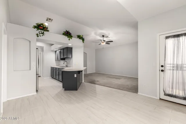 a view of living room with kitchen and window