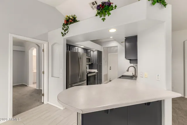a kitchen with kitchen island a counter top space appliances and cabinets