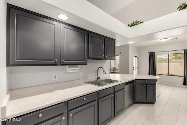 a kitchen with a sink and cabinets