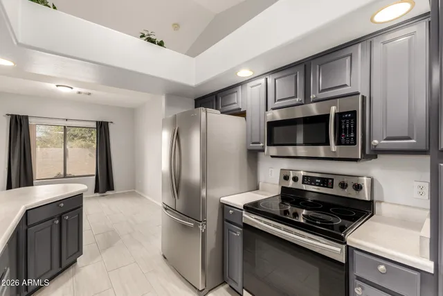 a kitchen with stainless steel appliances a refrigerator stove and microwave