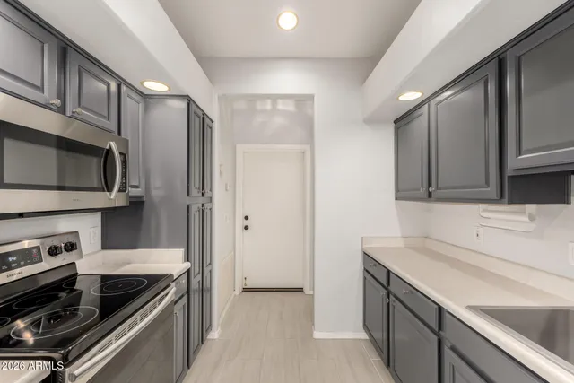 a kitchen that has a sink and stainless steel appliances