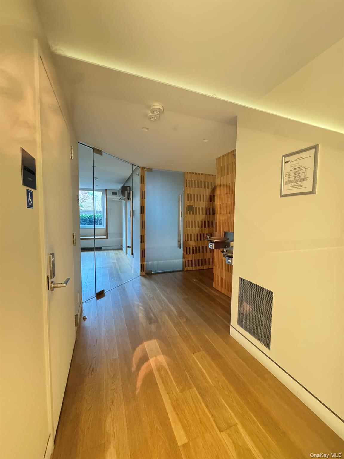 301 West 53rd Street, Unit 9K Manhattan, NY 10019 - Photo 18 of 22 Corridor featuring light wood-style flooring