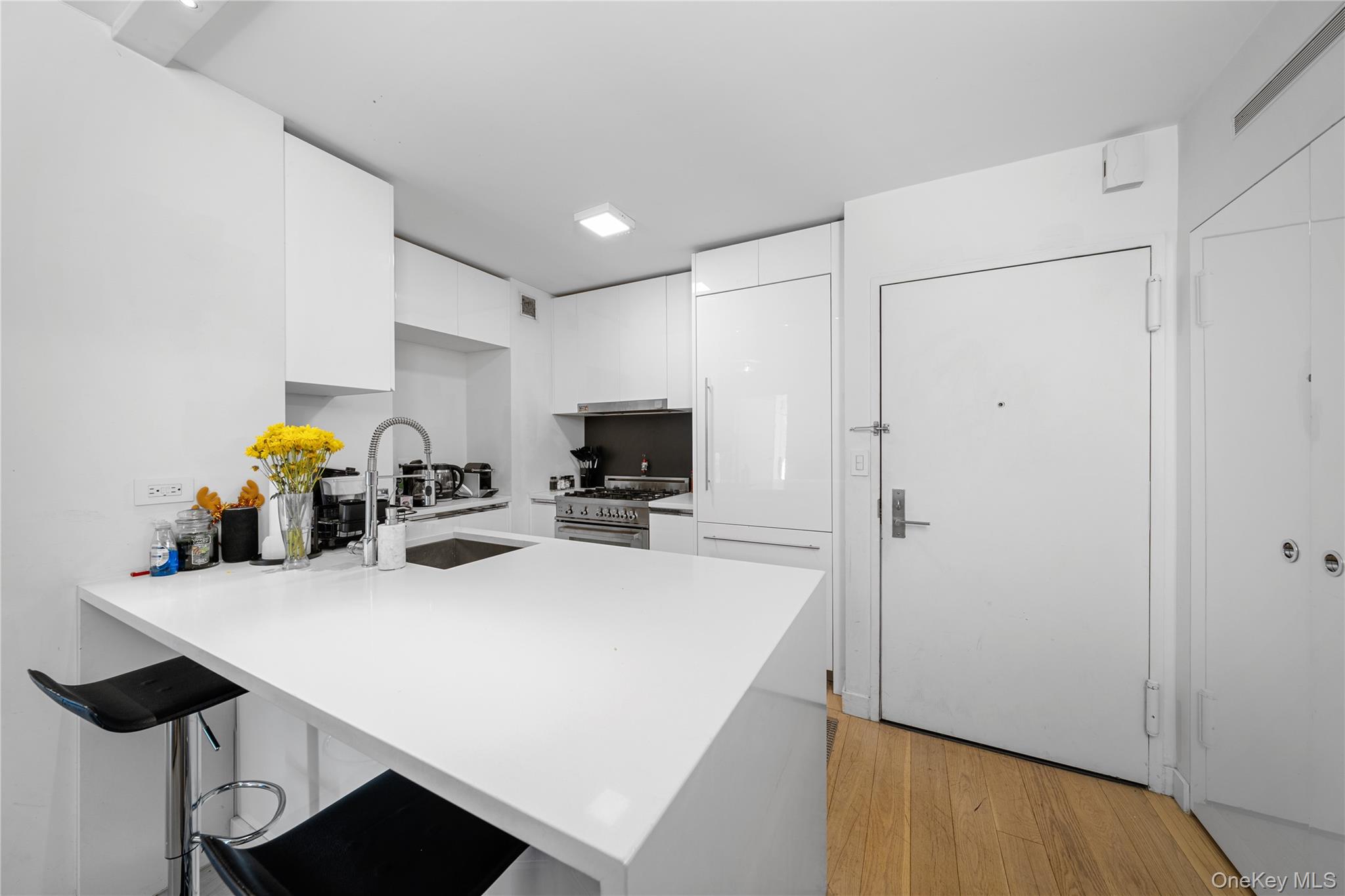 301 West 53rd Street, Unit 9K Manhattan, NY 10019 - Photo 30 of 40 a view of a kitchen with furniture and a to ceiling window
