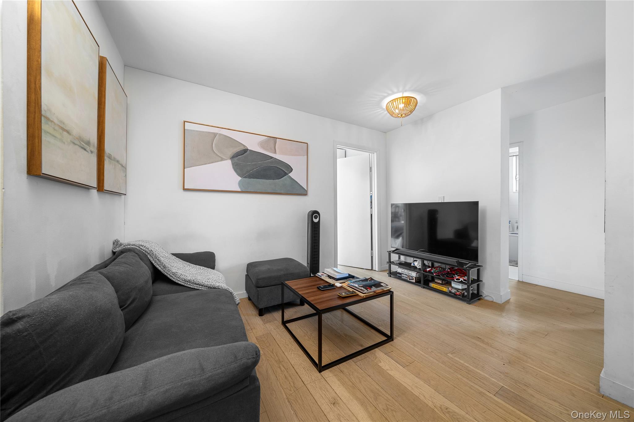 301 West 53rd Street, Unit 9K Manhattan, NY 10019 - Photo 31 of 40 a living room with furniture and a flat screen tv