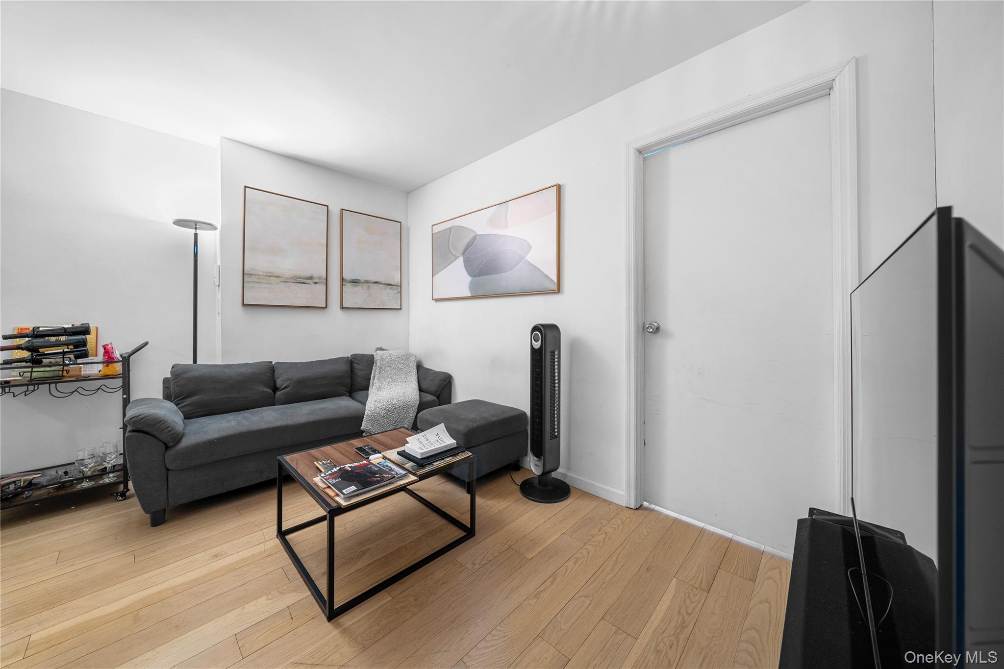 301 West 53rd Street, Unit 9K Manhattan, NY 10019 - Photo 32 of 40 a living room with furniture and a lamp