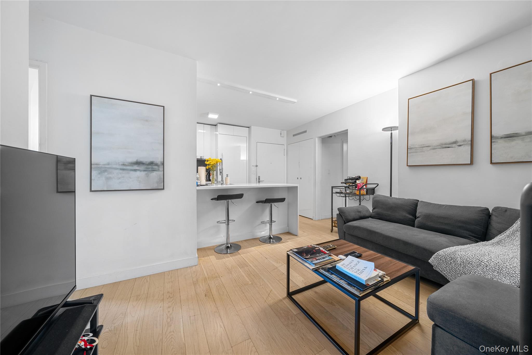 301 West 53rd Street, Unit 9K Manhattan, NY 10019 - Photo 33 of 40 a living room with furniture and a wooden floor