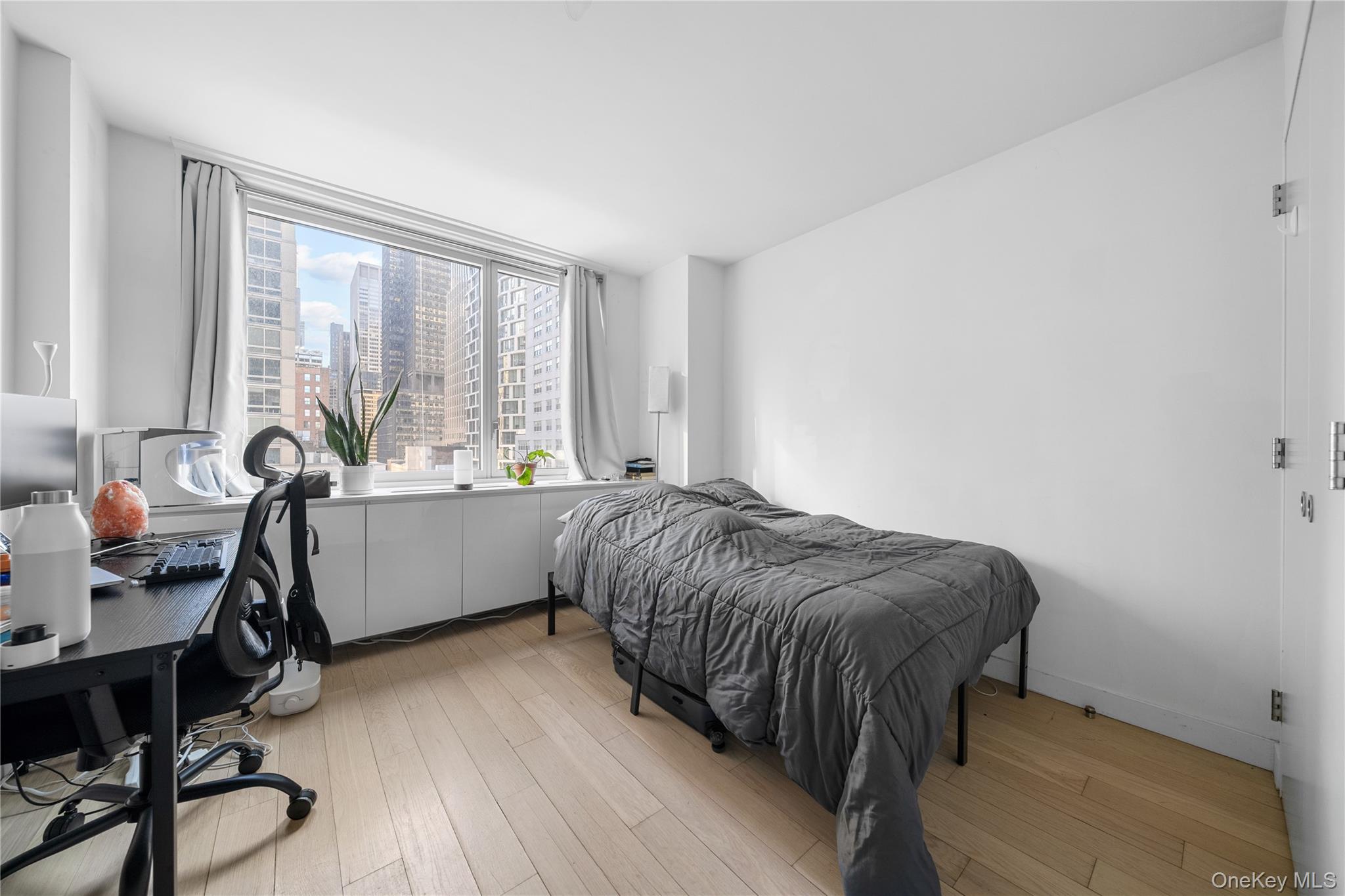 301 West 53rd Street, Unit 9K Manhattan, NY 10019 - Photo 37 of 40 a bed room with a bed and a chair