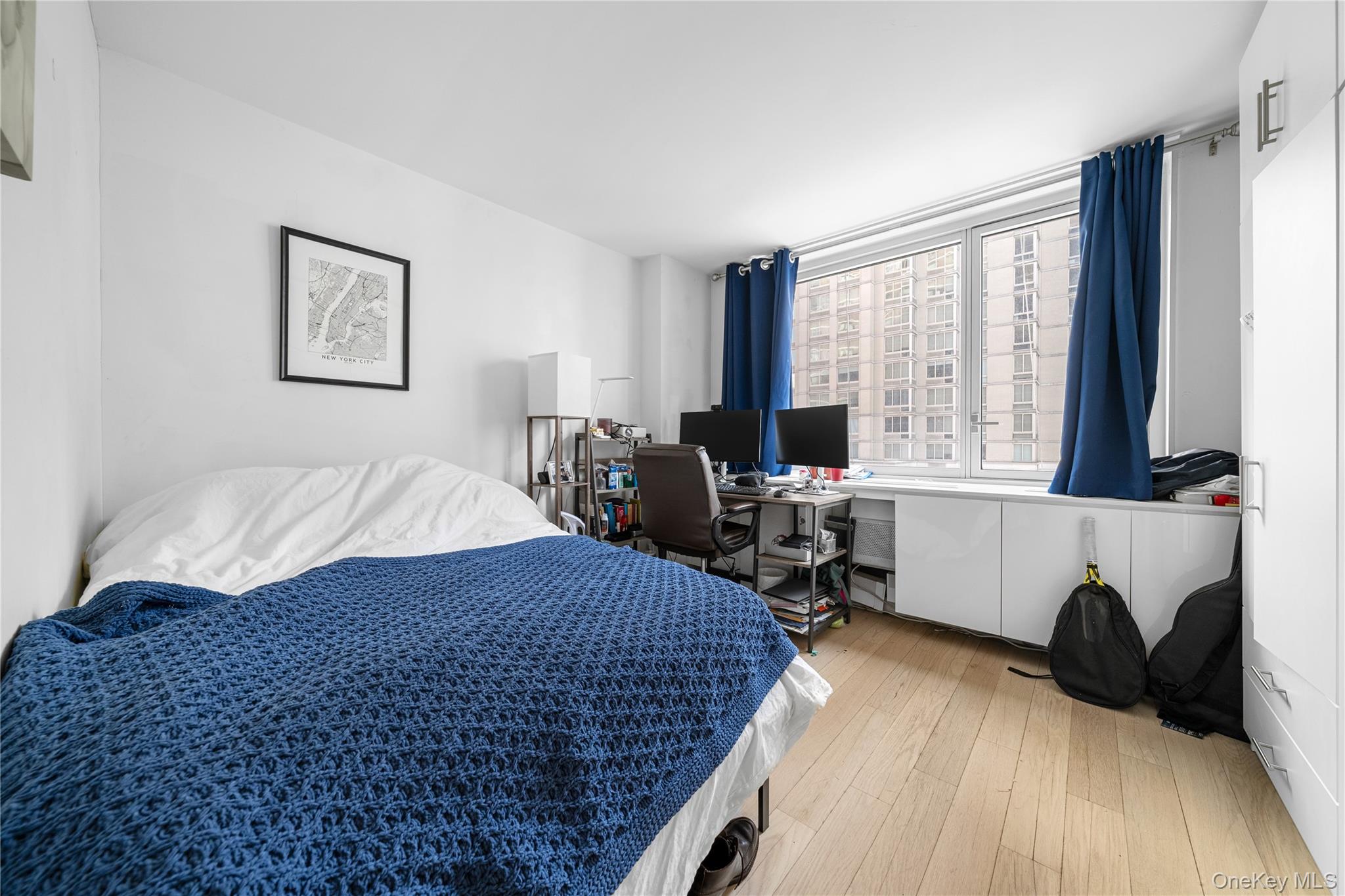 301 West 53rd Street, Unit 9K Manhattan, NY 10019 - Photo 38 of 40 a living room with a bed furniture and a large window