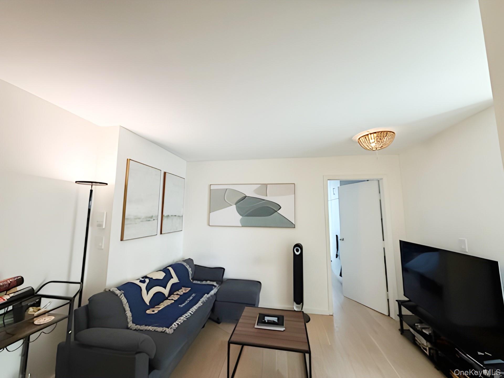 301 West 53rd Street, Unit 9K Manhattan, NY 10019 - Photo 6 of 22 Living area featuring wood finished floors