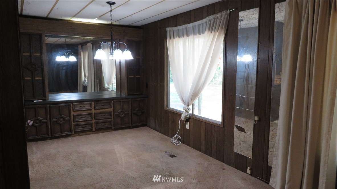 2058 Willeys Lake Road Custer, WA 98240 - Photo 19 of 25 a view of an empty room with a fireplace and a window