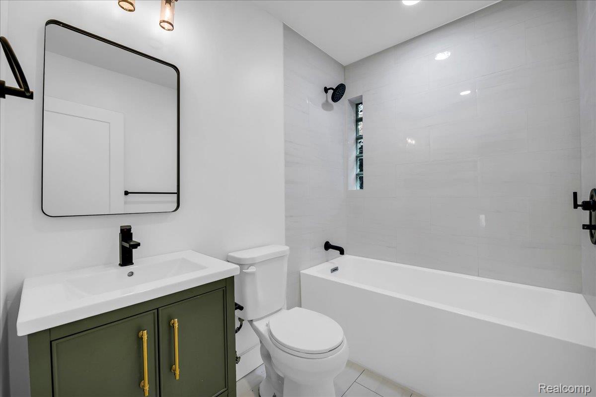2181 Harding Street Detroit, MI 48214 - Photo 19 of 32 Full bath with vanity, shower / washtub combination, and light tile patterned floors