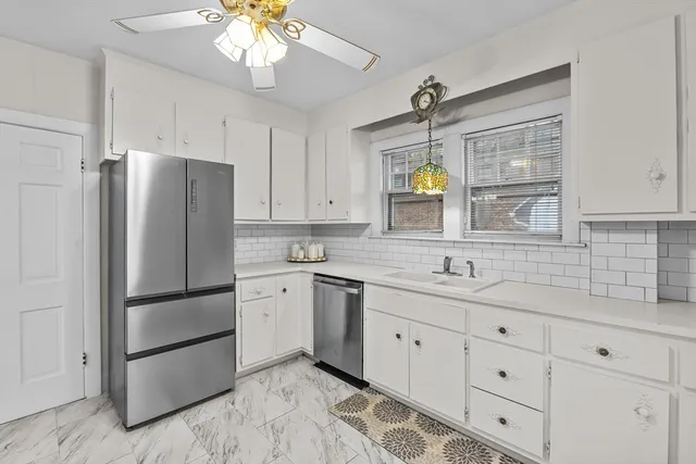 a kitchen with a refrigerator and a sink