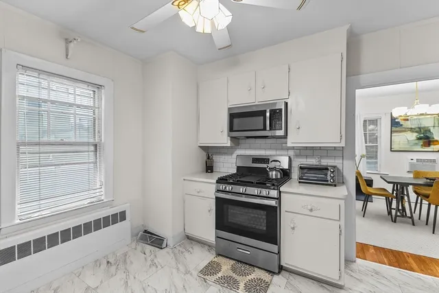 a kitchen with stainless steel appliances a stove a sink and a microwave