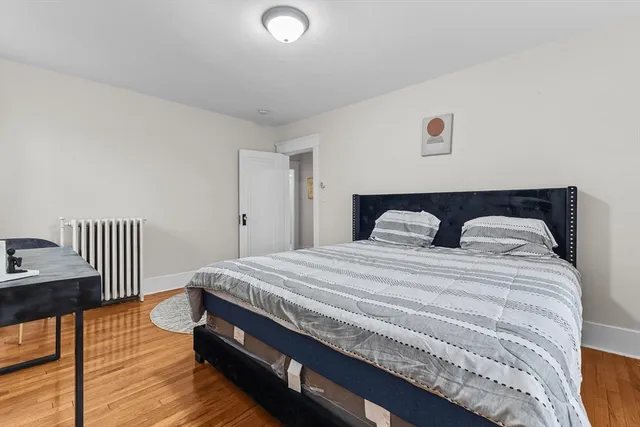 a bed sitting in a bedroom next to a window