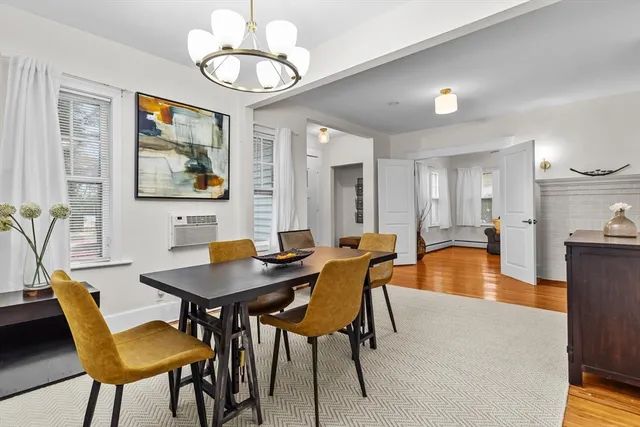 a view of a dining room with furniture wooden floor and a chandelier