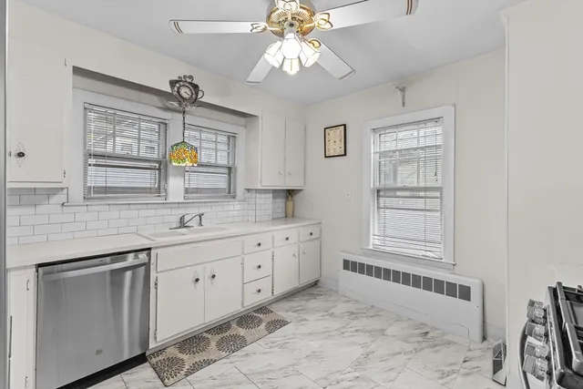 a spacious bathroom with a granite countertop sink mirror and bathtub