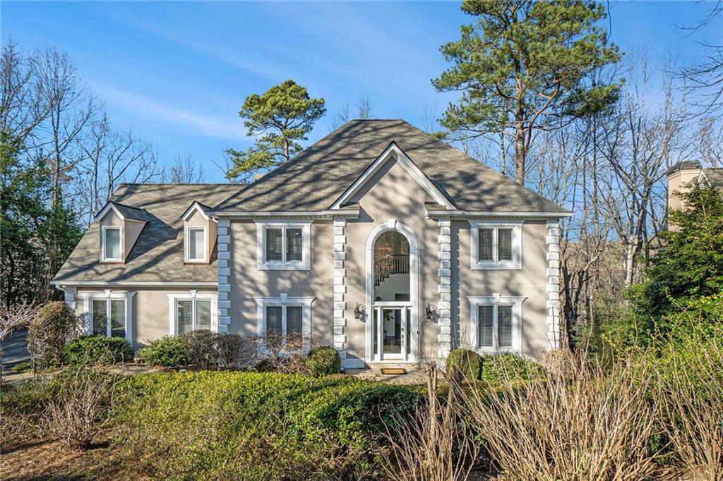 8240 Sullivan Hill Road Sandy Springs, GA 30350 - Photo 1 of 1 a front view of a house with a garden