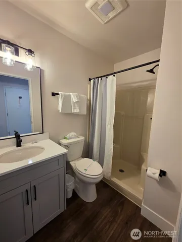 a bathroom with a sink toilet and shower