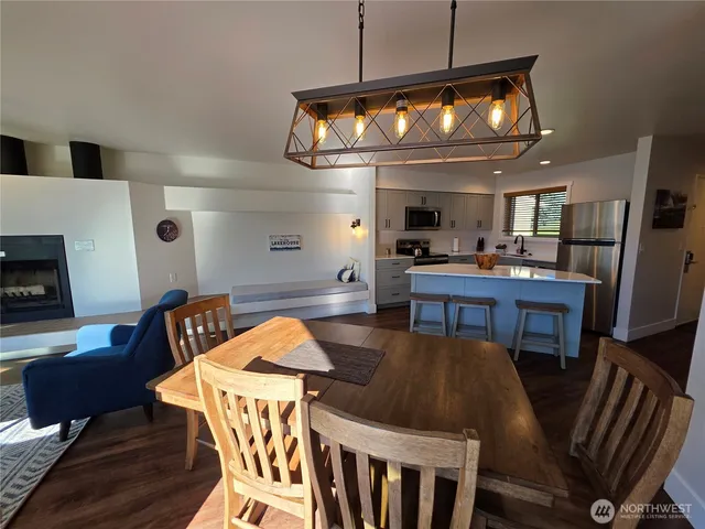 a view of a dining room with furniture and a chandelier