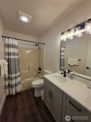 a bathroom with a double vanity sink toilet and shower