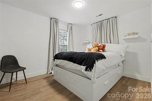 a bedroom with a bed and a chair