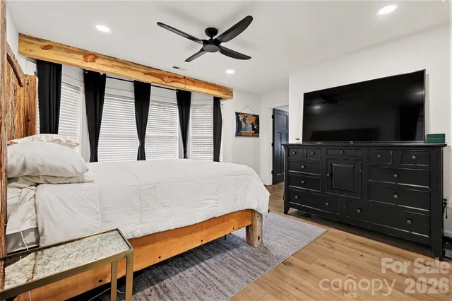 a bedroom with a bed and a flat screen television