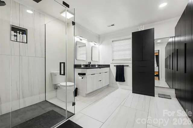a kitchen with white cabinets and refrigerator