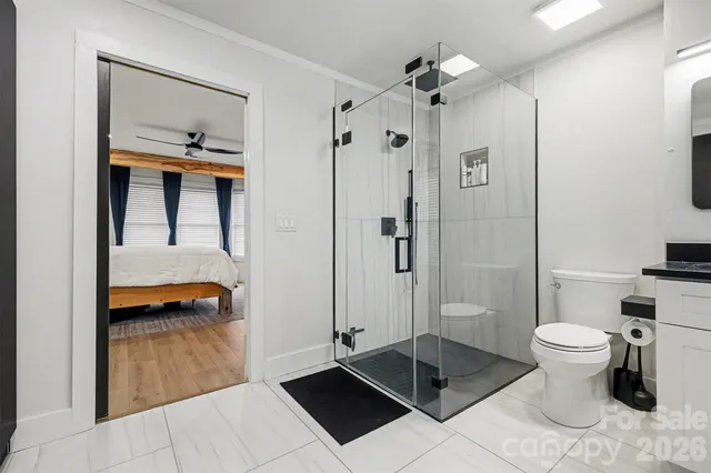 a bathroom with a shower sink and toilet