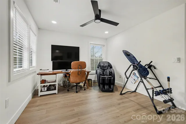 a view of a workspace with furniture and a window