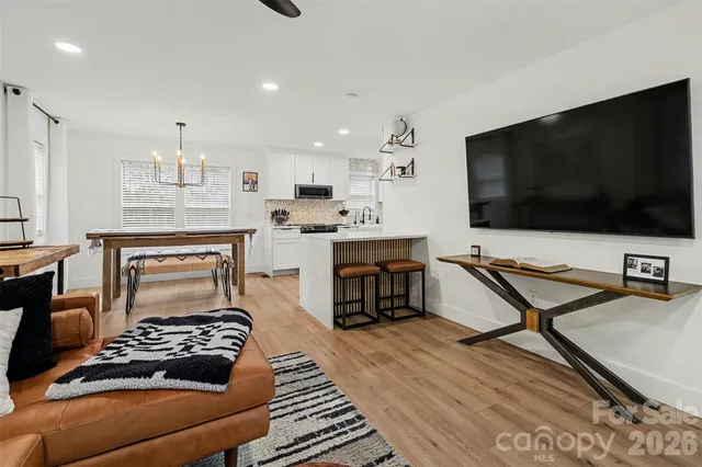 a kitchen with a stove and a flat screen tv