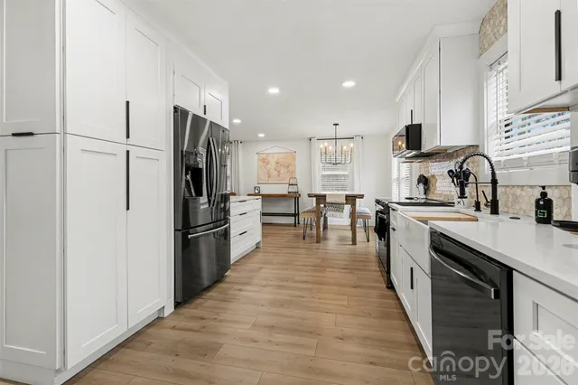 a kitchen with stainless steel appliances granite countertop a refrigerator stove and sink