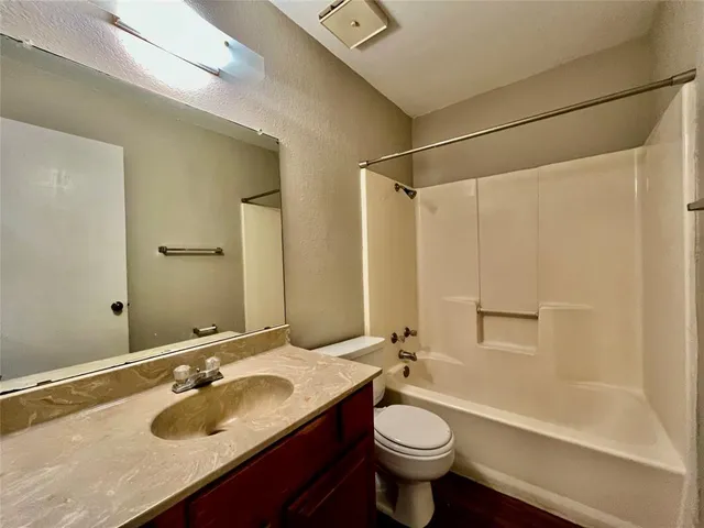 a bathroom with a sink toilet a mirror and shower