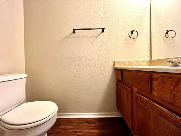 a bathroom with a toilet a sink and vanity